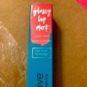 Thrive glossy lipstick misty color which is a coral color thrive cosmetics NIB
